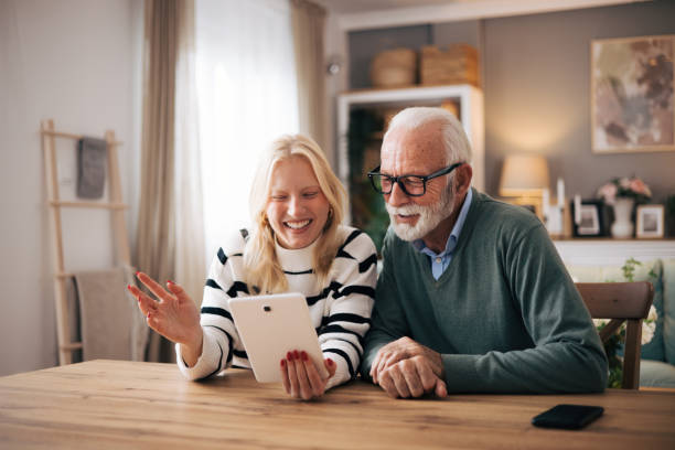 istock Granddaughter and grandfather using tablet computer to video call loved ones 1851442529