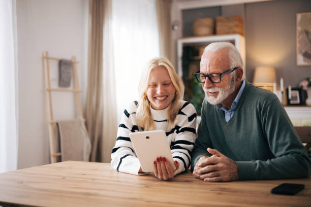 istock Granddaughter and grandfather using tablet computer to video call loved ones 1851444739