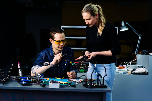 istock Man and woman engineers working on racing fpv drone in workshop 1851445197