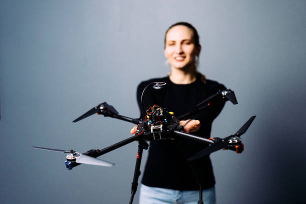 istock Engineer holding fpv racing drone on blue background. Starting motors 1851445308