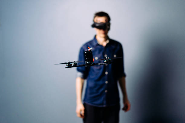 istock Engineer holding fpv racing drone on blue background. Starting motors 1851445834