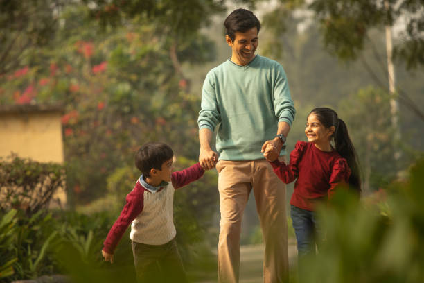 istock Father with children enjoying in park 1851472217