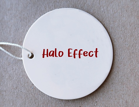 Price tag with text written Halo Effect -  cognitive bias in which overall impression of person, influences how we feel and think about their character