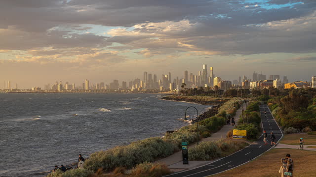 Day to night Time lapse of Melbourne Point Ormond Lookout and Observation with sport Public park with bicycle lane over the Melbourne Cityscape in Central Business District of Melbourne City, Victoria, Australia
