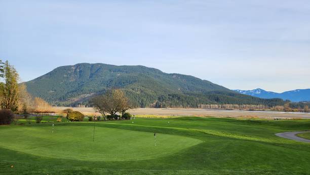 istock A golf course surrounded by mountains with afternoon sunlight sprayed on ground 1851515659