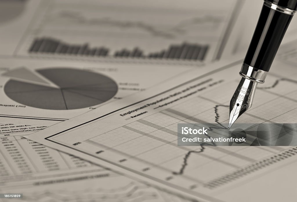 Fountain pen on stock chart. Fountain pen on a stock chrt creating a scene of analysis and research. Analyzing Stock Photo
