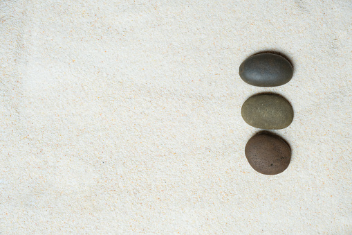 Top view, of stones placed on sand, concept japanese zen garden stone balance