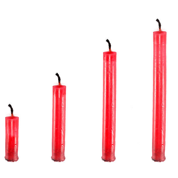 istock Four red candles in front of white background 185152726