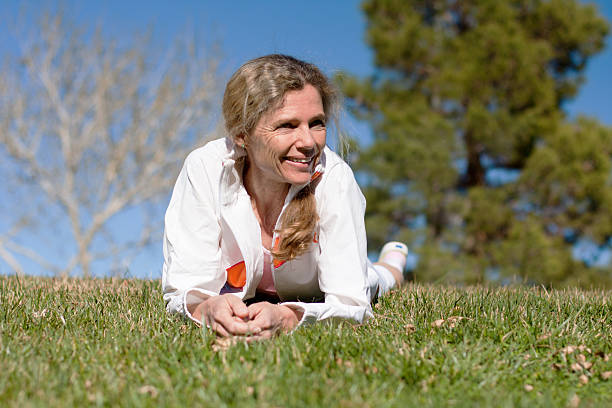 mature female laying in grass stock photo