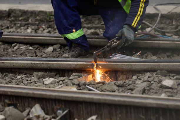 istock Details with a worker using an oxy-acetylene torch to cut metal tramway tracks. 1851549074