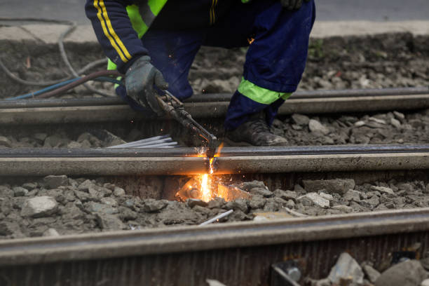 istock Details with a worker using an oxy-acetylene torch to cut metal tramway tracks. 1851549075