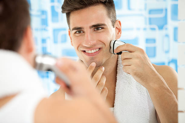 istock man shaving with electric shaver 185155611