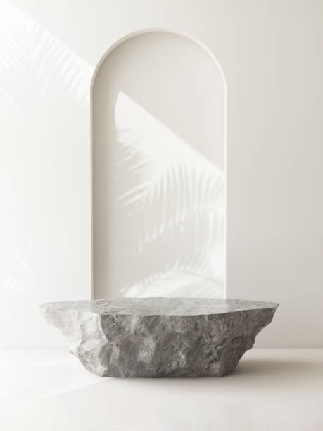 istock Gray rock stone podium table in sunlight, palm tree leaf shadow on wall arch 1851569383