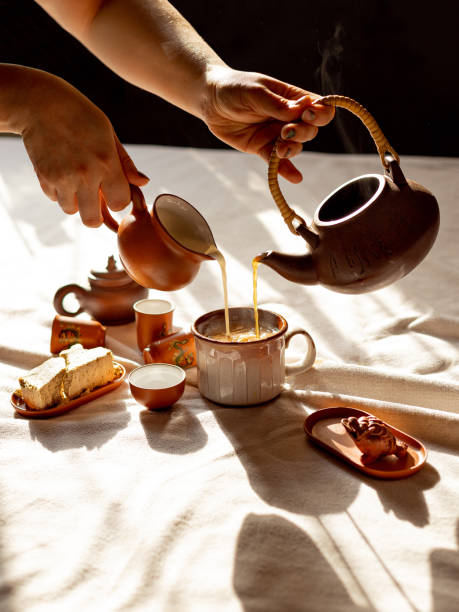 istock tea party, female hand pours tea 1851591682