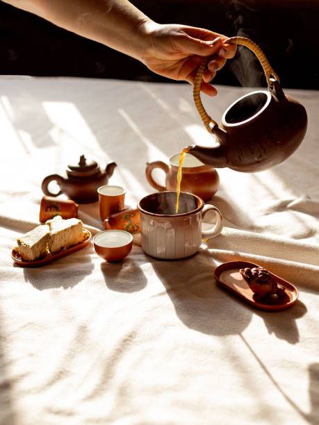 istock tea party, female hand pours tea 1851592731