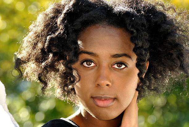 istock beautiful young woman looking at the camera 185160162