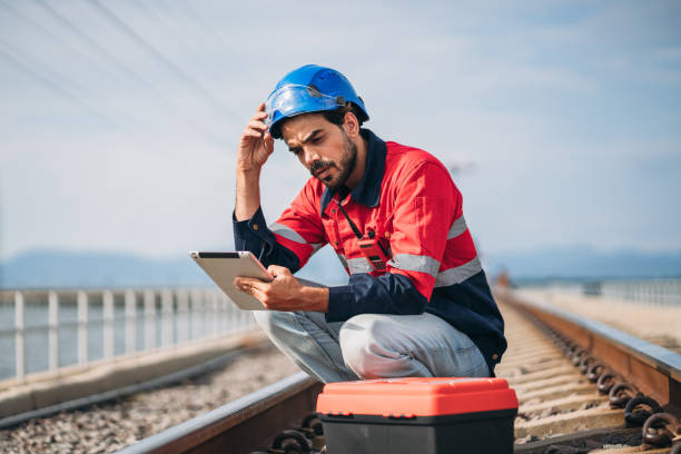 istock Service Engineer inspecting and maintenance railroad tracks. Industrial Worker checking and working of machines. 1851604758