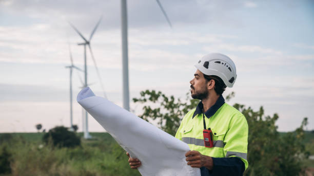 istock Service engineers checking system of windmill at wind farm. Wind turbines generate electricity. Clean and Renewable energy concept. 1851606365