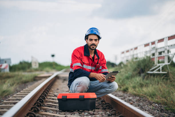 istock Service Engineer inspecting and maintenance railroad tracks. Industrial Worker checking and working of machines. 1851606890