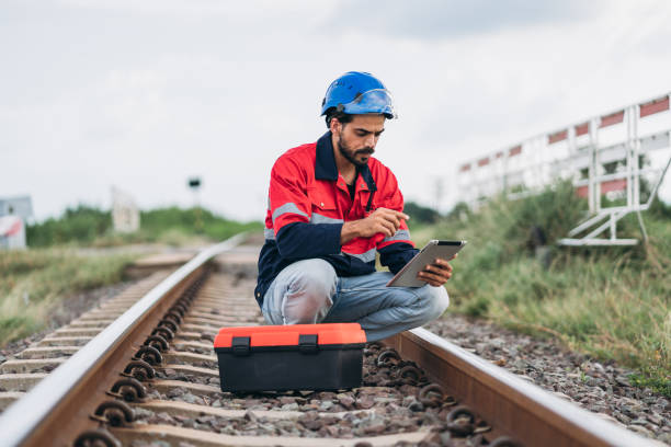 istock Service Engineer inspecting and maintenance railroad tracks. Industrial Worker checking and working of machines. 1851613136