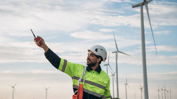 istock Service engineers checking system of windmill at wind farm. Wind turbines generate electricity. Clean and Renewable energy concept. 1851614169