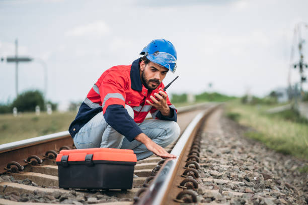 istock Service Engineer inspecting and maintenance railroad tracks. Industrial Worker checking and working of machines. 1851615217