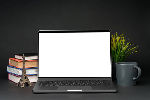 istock Laptop with blank screen on table against black background 1851621035