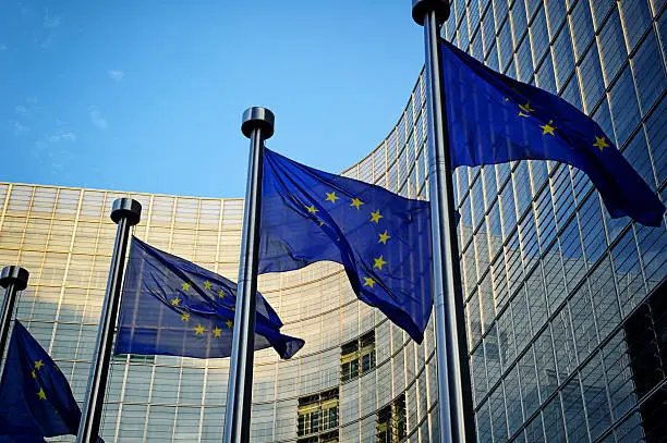 EU flags in front of European Commission building in Brussels