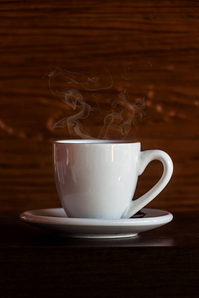 istock White cup of coffee on wooden background 185166541