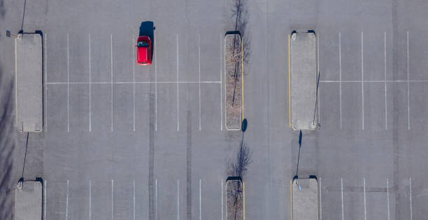 istock A red car is parked in an empty parking lot 1851668719