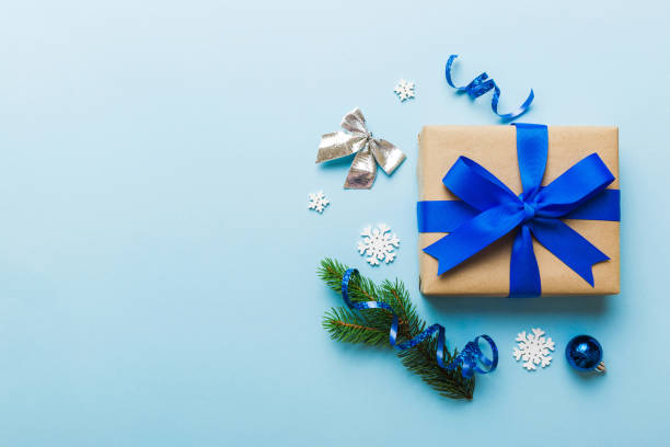 istock Top view Flat lay Christmas decorations and gift box on colored background with copy space. Christmas or Happy New Year composition 1851676347