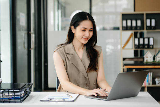 istock Young beautiful woman using laptop and tablet while sitting at her working place. Concentrated at work. 1851683201