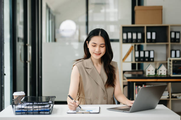 istock Young beautiful woman using laptop and tablet while sitting at her working place. Concentrated at work. 1851684785