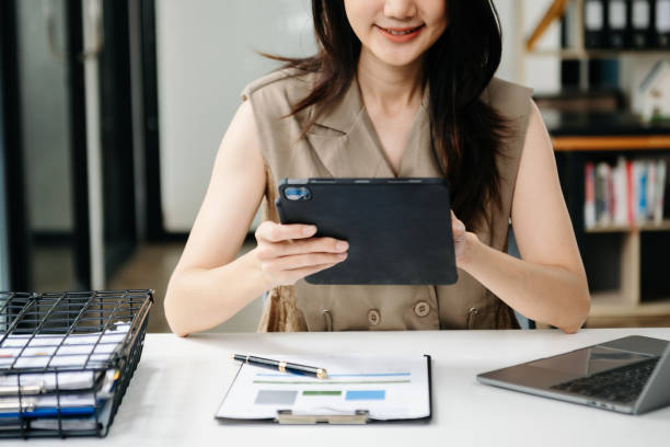 istock Young beautiful woman using laptop and tablet while sitting at her working place. Concentrated at work. 1851685054