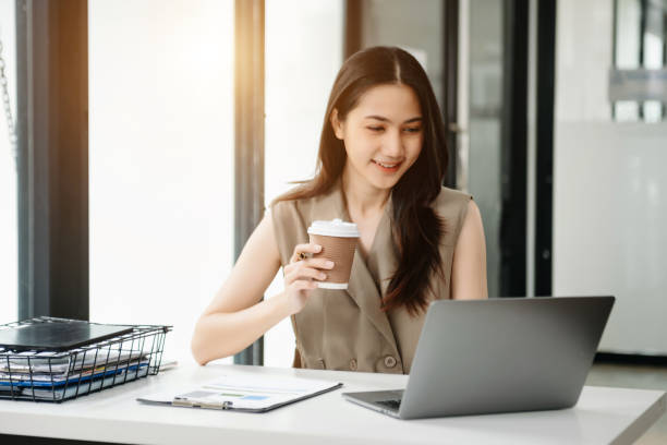 istock Young beautiful woman using laptop and tablet while sitting at her working place. Concentrated at work. 1851685302