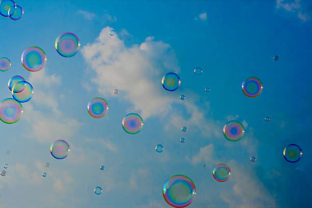 istock blowing soap bubbles in the sky and clouds 185168818