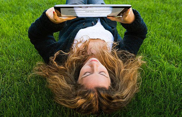 Reading news on digital tablet stock photo