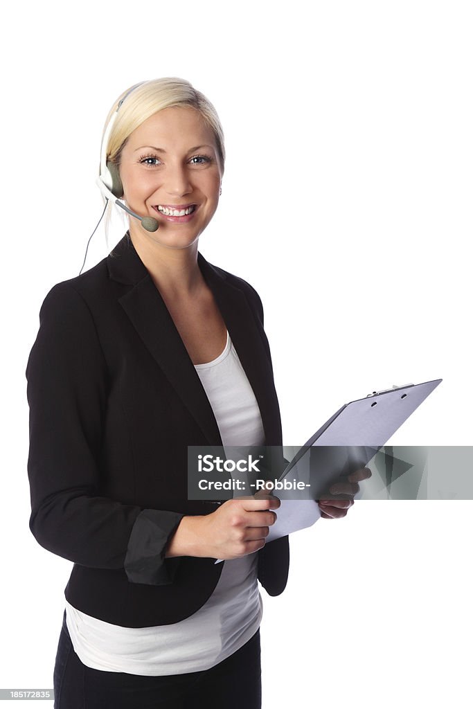 Let me help you! Attractive business woman wearing a black jacket with a white shirt. Wearing a headset and holding a clipboard. White background. 20-29 Years Stock Photo