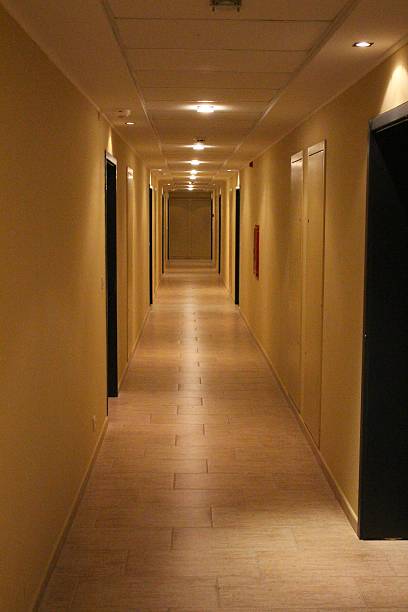 istock Long light hotel corridor with blind wall at the end 185173412