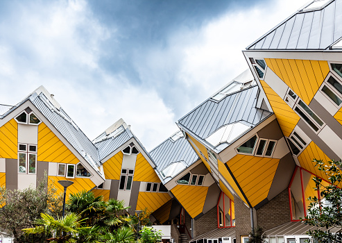 Rotterdam, Netherlands - July 28, 2023: Cube houses are an architectural ensemble of thirty-eight cubic houses located over Blaak street, designed by dutch architect Piet Blom and built in 1984.