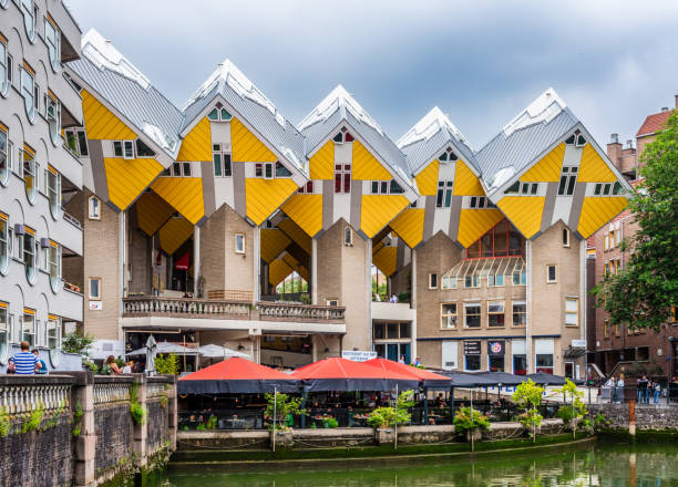 Rotterdam, Netherlands - July 28, 2023: South-east side of the Cube houses, a thirty-eight cubic houses complex designed by dutch architect Piet Blom and built in 1984, overlooking the Old Port.