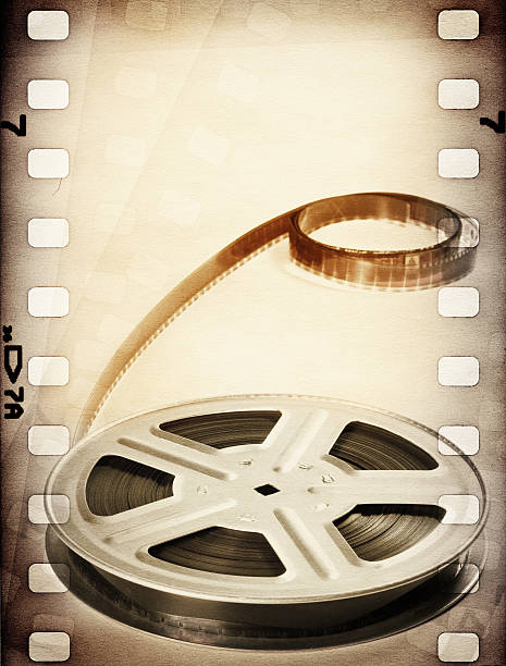 Old motion picture film strip reel. Vintage background Old motion picture film strip reel. Vintage background reel to reel tape stock pictures, royalty-free photos & images