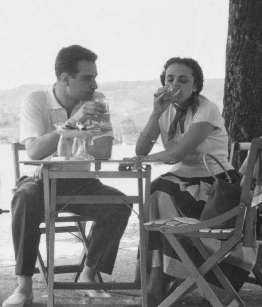 istock Young couple sitting in a sidewalk cafe. 1958. 1851772494