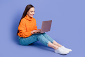 Full body photo of business lady netbook searching information using high productivity macbook pro air isolated on violet color background