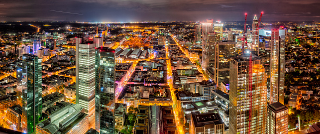 Panoramic view over the skyline of Frankfurt am Main in the evening with illuminated streets of the city center and skyscrapers