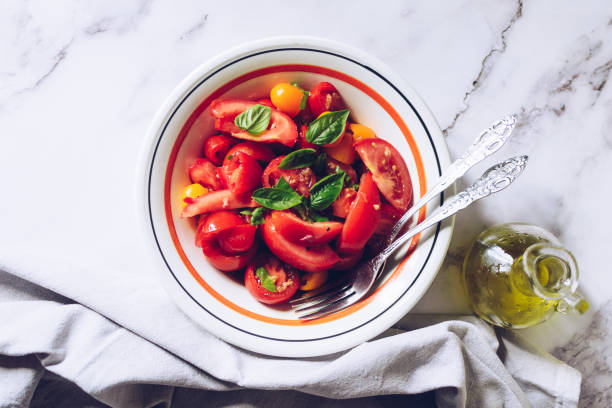 Healthy salad with different types of tomatoes and basil