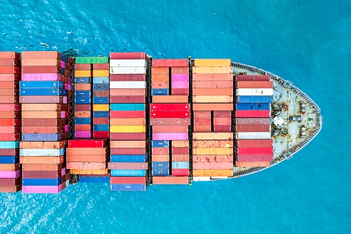 Aerial top view container ship full load container for logistics at blue sea.