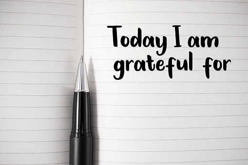 Gratitude concept with pen and message on notebook