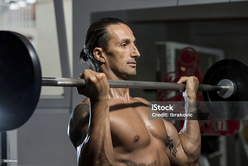 Человек в тренажерном зале, физические упражнения бицепсы с застежкой в виде штанги - Стоковые фото 30-39 лет роялти-фри