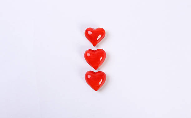 istock Three red glass heart in the row above each 185181908
